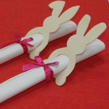 Serviettenhalter aus Holz im Osterhasenmotiv auf einem roten Tuch